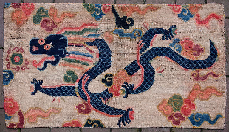 Tibetan cushion cover (Jabuye) with rare design of a dragon amongst clouds. 
Cushion covers have been very popular in Tibet but they usually have geometric or floral designs, dragons are rarely found on this type of rug. This energetic little