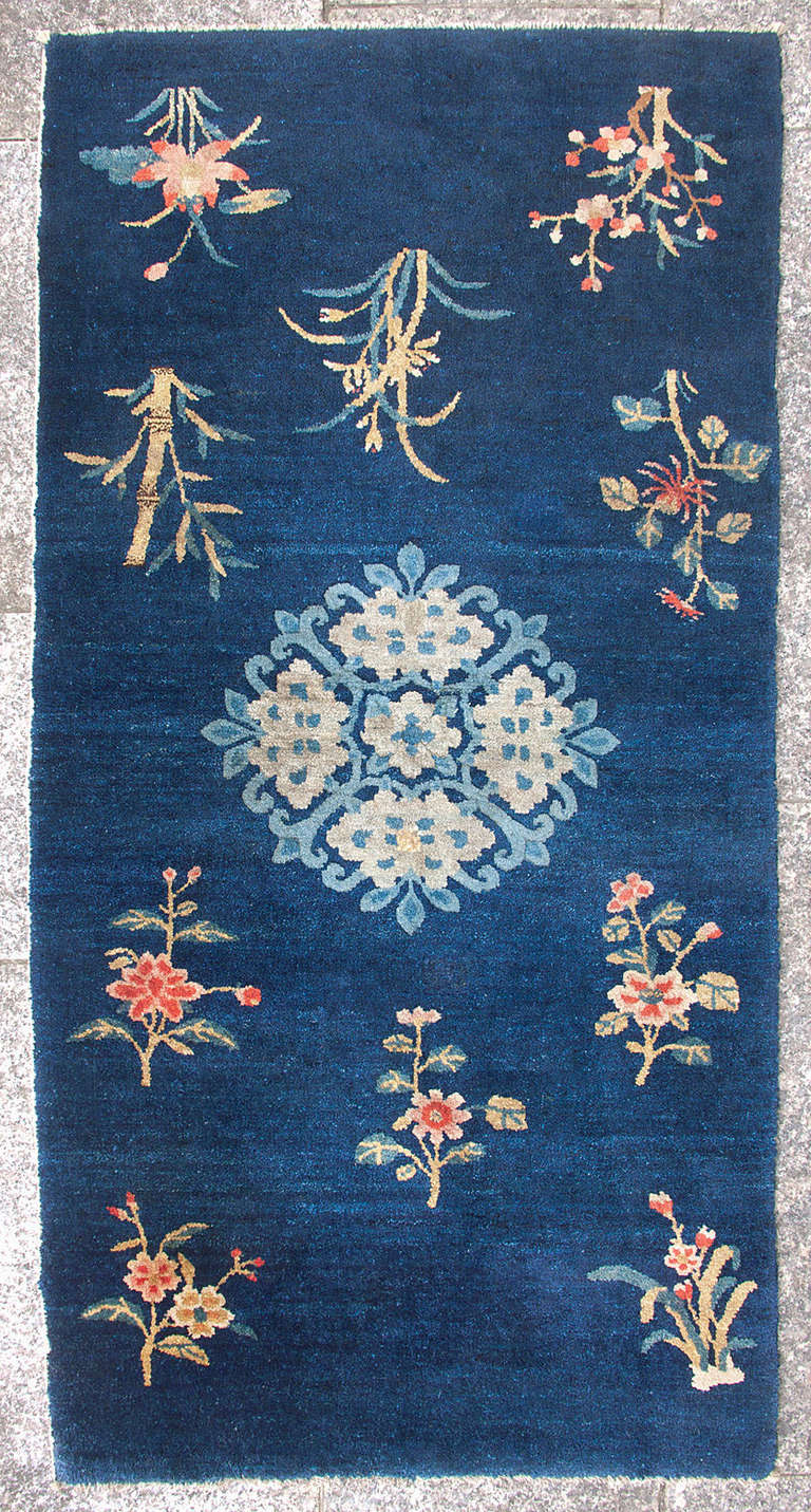 ***SUMMER SALE***
This indigo blue Baotou-Suiyuan rug has an open field design with an array of flowers and bamboo. 

Baotou has an unrivalled expertise in using the indigo root to dye the excellent Inner Mongolian wool. The results are apparent in