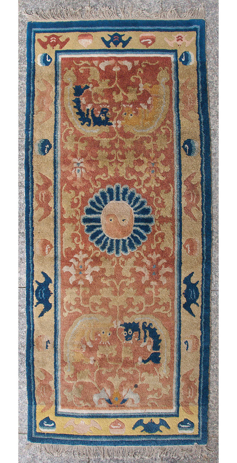***Autumn SALE***
A very harmonious and calming piece, this rug used to grace the monks’ sitting rows in a Buddhist temple. 
Two pairs playing fo-dogs on a field of scrolling lotus flowers and vines surround the central medallion in the shape of a