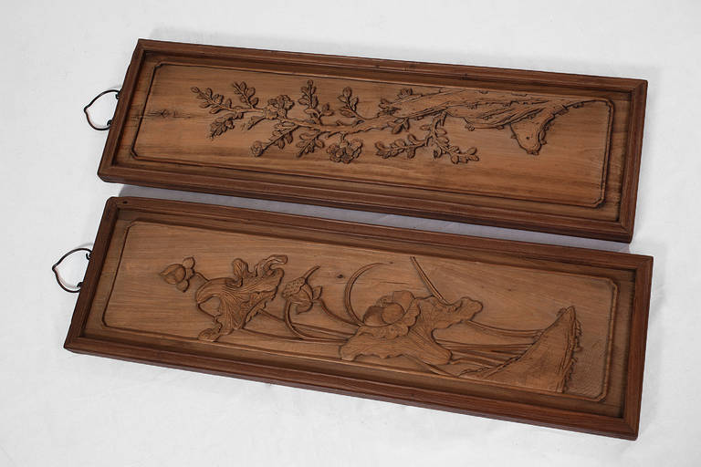 This pair of antique Chinese pine wood architectural panels were hand-carved by master carpenters. 

Originally part of a wooden home or temple, these pieces bear witness to the beauty and effort put into building Dwellings in the past. The