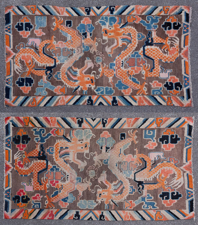 ***SUMMER SALE***
This pair of extremely charming Tibetan double dragon rugs is a lucky find. Many pairs were split up when they were handed down or sold so finding a pair is very exciting. 

The classic depiction of two dragons playing amongst the