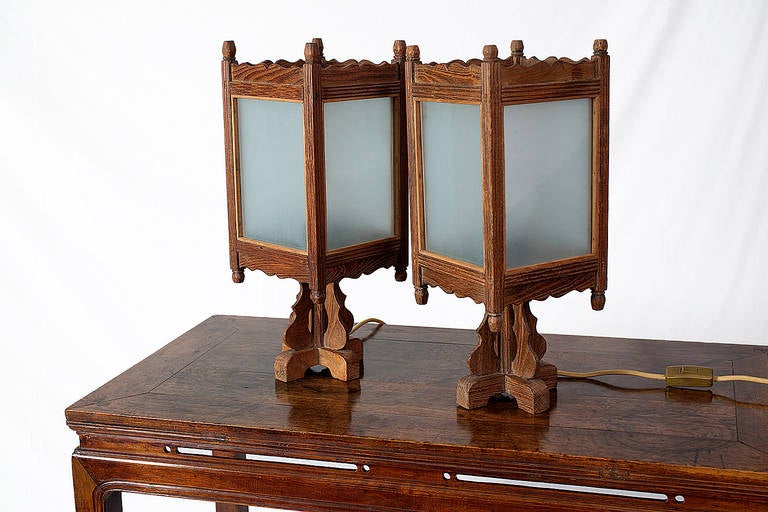 A decorative pair of 18th century Shanxi province elm wood table lantern stands with original lanterns. The removable lanterns sit within the lipped border of the platform. The lanterns would have originally been fitted with paper, which has been