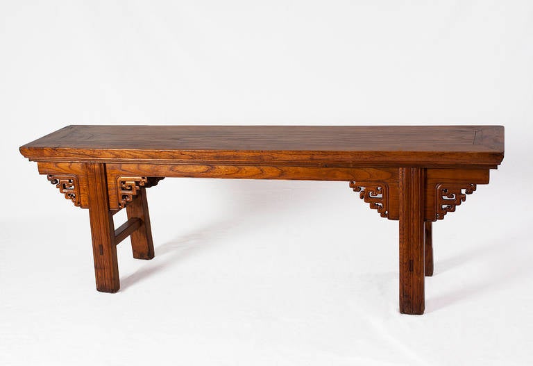 Elegantly crafted from warm hued southern elmwood, this 19th century bench comes from Shanxi province. 

This bench is beautifully shaped and well-proportioned with lightly tapered legs and nicely carved aprons. The top shows off the lovely wood