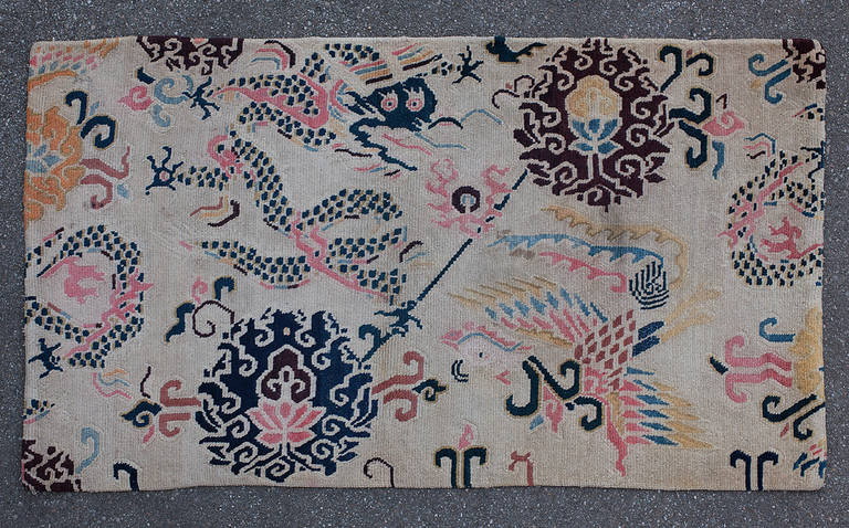 Lovely antique ivory ground Tibetan Khaden with dragon and phoenix design. 

This rug depicts a very unusual version of the all-over design based on Chinese Ming dynasty silks, very popular in ancient Tibet. Two large lotus flowers with a dragon