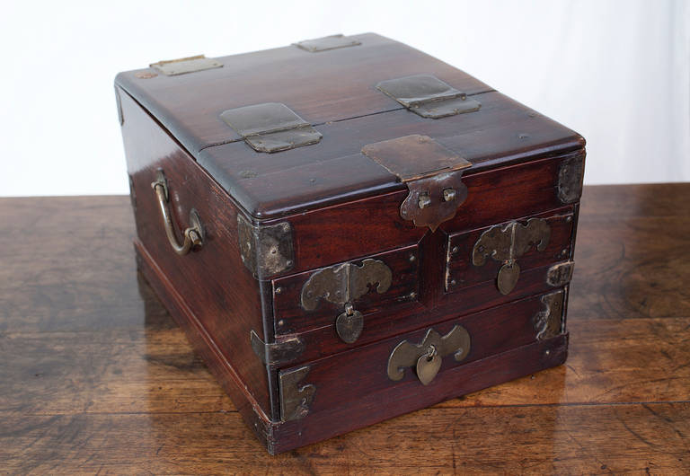 This charming Southern Chinese jewellery box is made from the finest rosewood. 

Elegantly proportioned, this box is decorated with brass fittings, some in the shape of butterflies, and brass handles on the side. Three drawers can be used to store