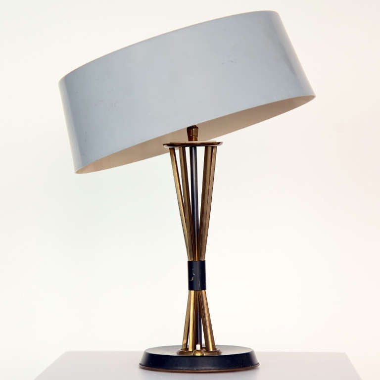 Table lamp by Oscar Torlasco for Lumi.  Movable shade, tilts in all directions.
