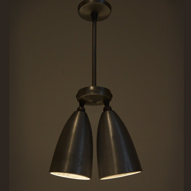 pair of double cone Swiv-O-Lite pendants manufactured by Prescolite .

Cones can be rotated individually
cones meassure height : 24 cm , diameter 15 cm