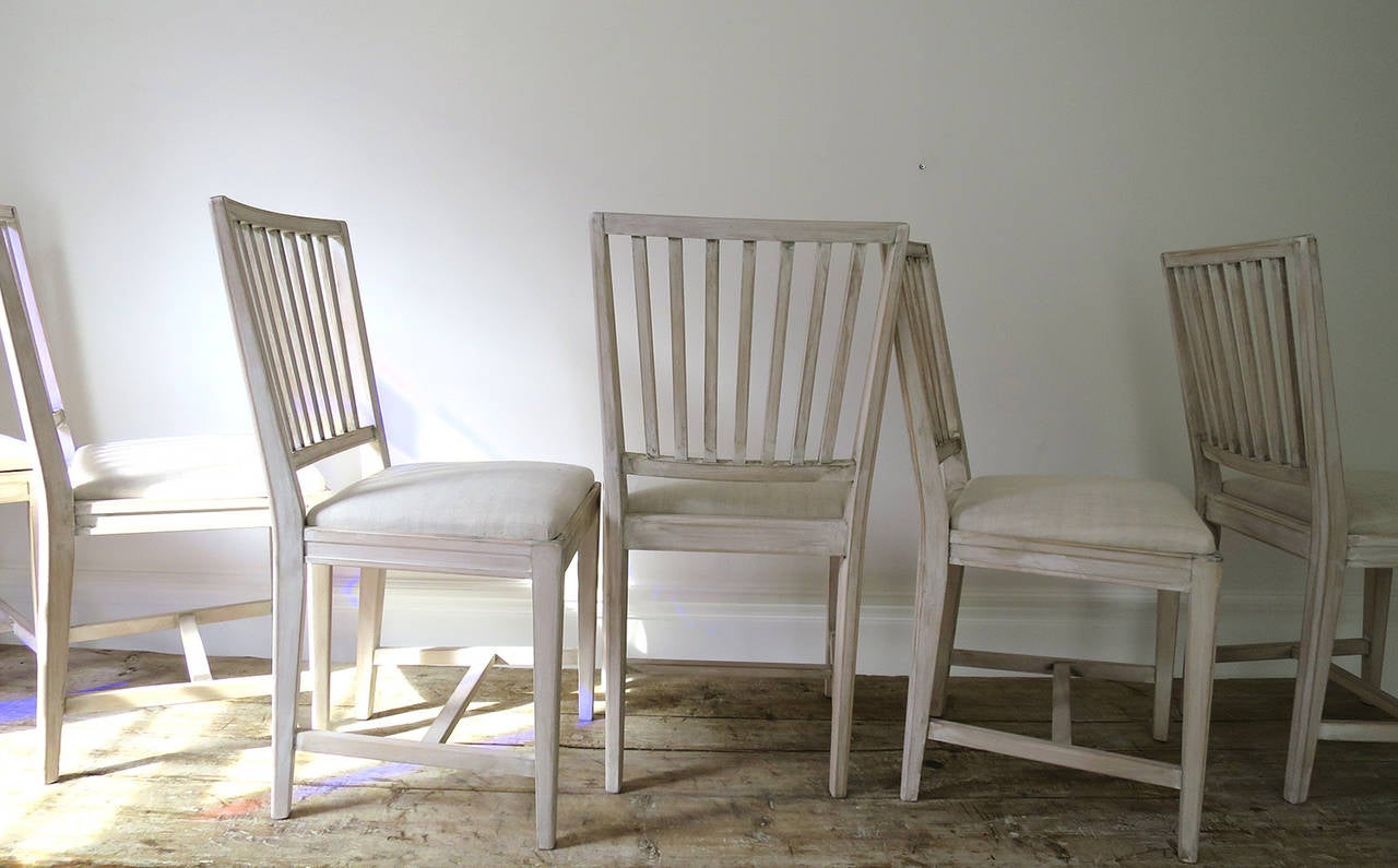 A classic set of no-nonsense Swedish Dining Chairs with lift out seats covered with antique cream linen.  All in excellent condition.