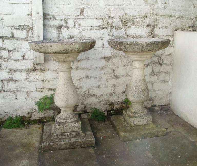 A pair of English composition stone birdbaths circa 1900, in very good condition with a nice patination