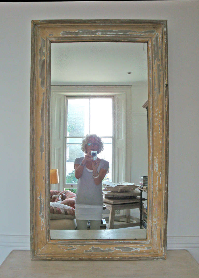 19th century picture frame mirror with aged glass with layers of old yellow and white paint