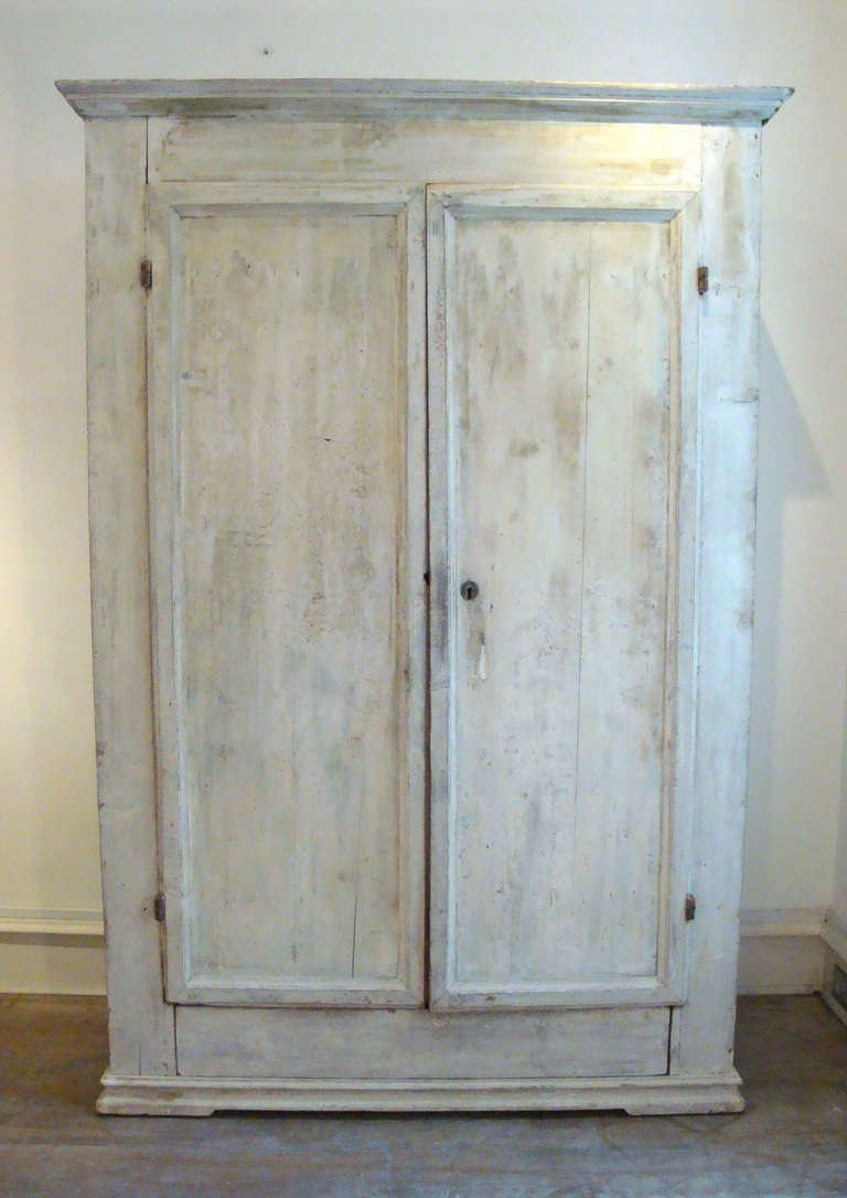 18th century, Italian Tuscan armoire with old white paint and original lock.