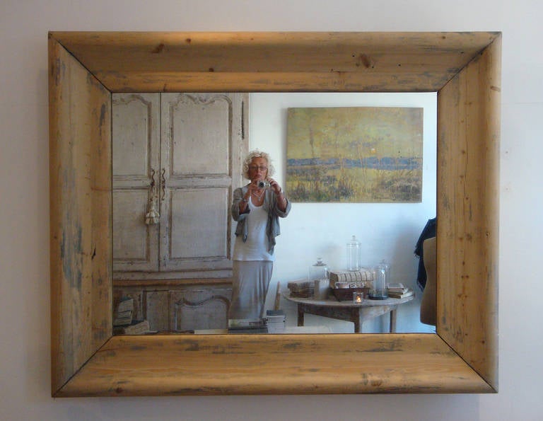 Large 19th century pine mirror with a wide frame and old glass mirror.