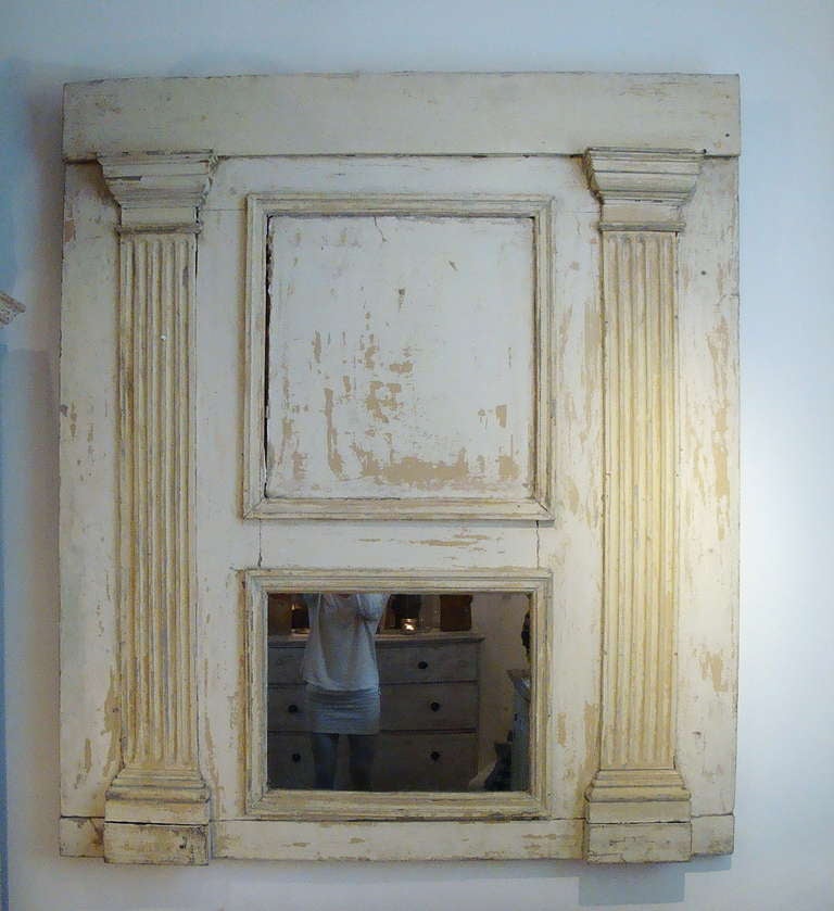 A large French 19th century Trumeau mirror with remains of old paint, with original glass
