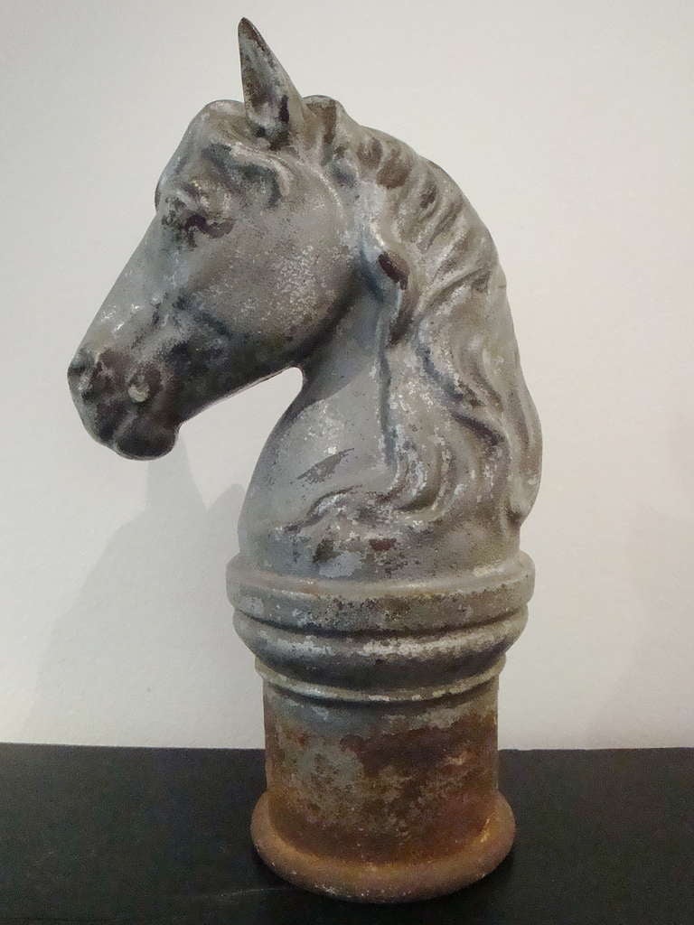 Cast iron Horse`s Head from the entrance to the stall in an old, rather smart stables - in good condition - this one has been painted with a silvery paint at some time in the past. The head would have been mounted on a cast iron post at the entrance