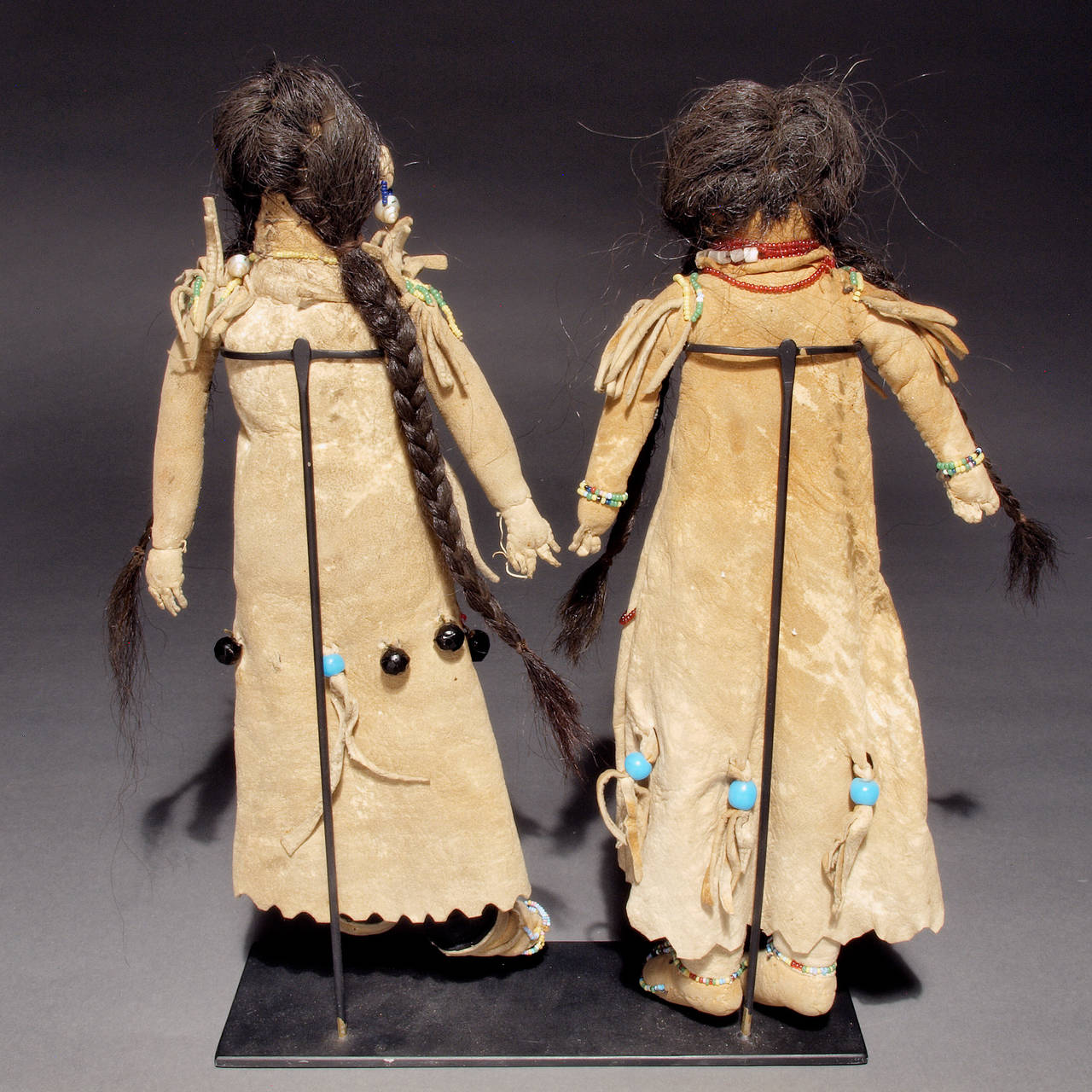 Created in the late 19th century, these authentic Northwest Coast Native American Indian dolls are depicted wearing traditional Athapaskan dress. Constructed of native tanned hide and sinew-sewn with trade beads and horse hair.

Custom display