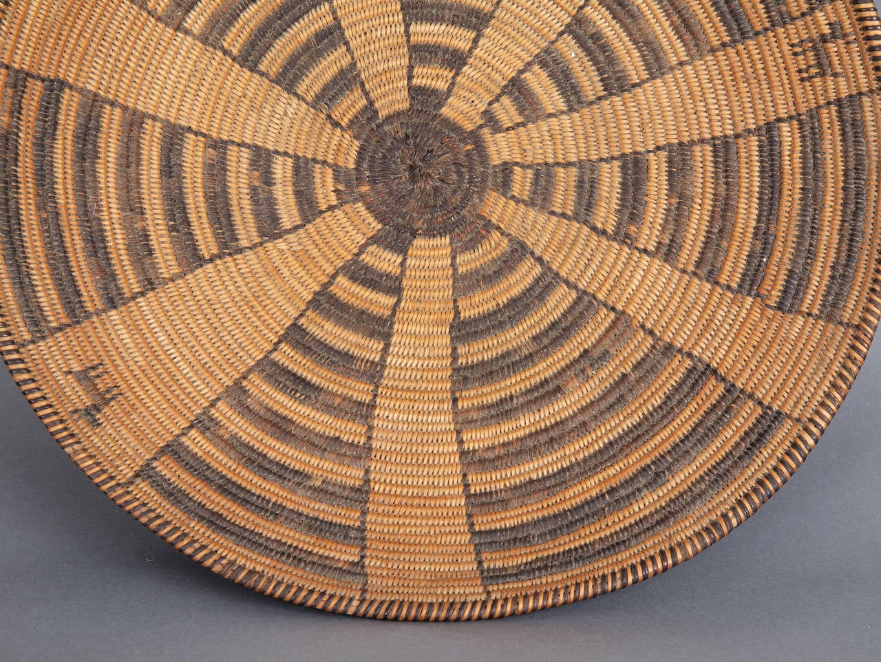 This Southwestern American Indian shallow bowl or tray form is finely woven of willow and devil's claw. A geometric design is enhanced with three dog forms.

Expedited and International shipping is available; please contact us for a quote.

As