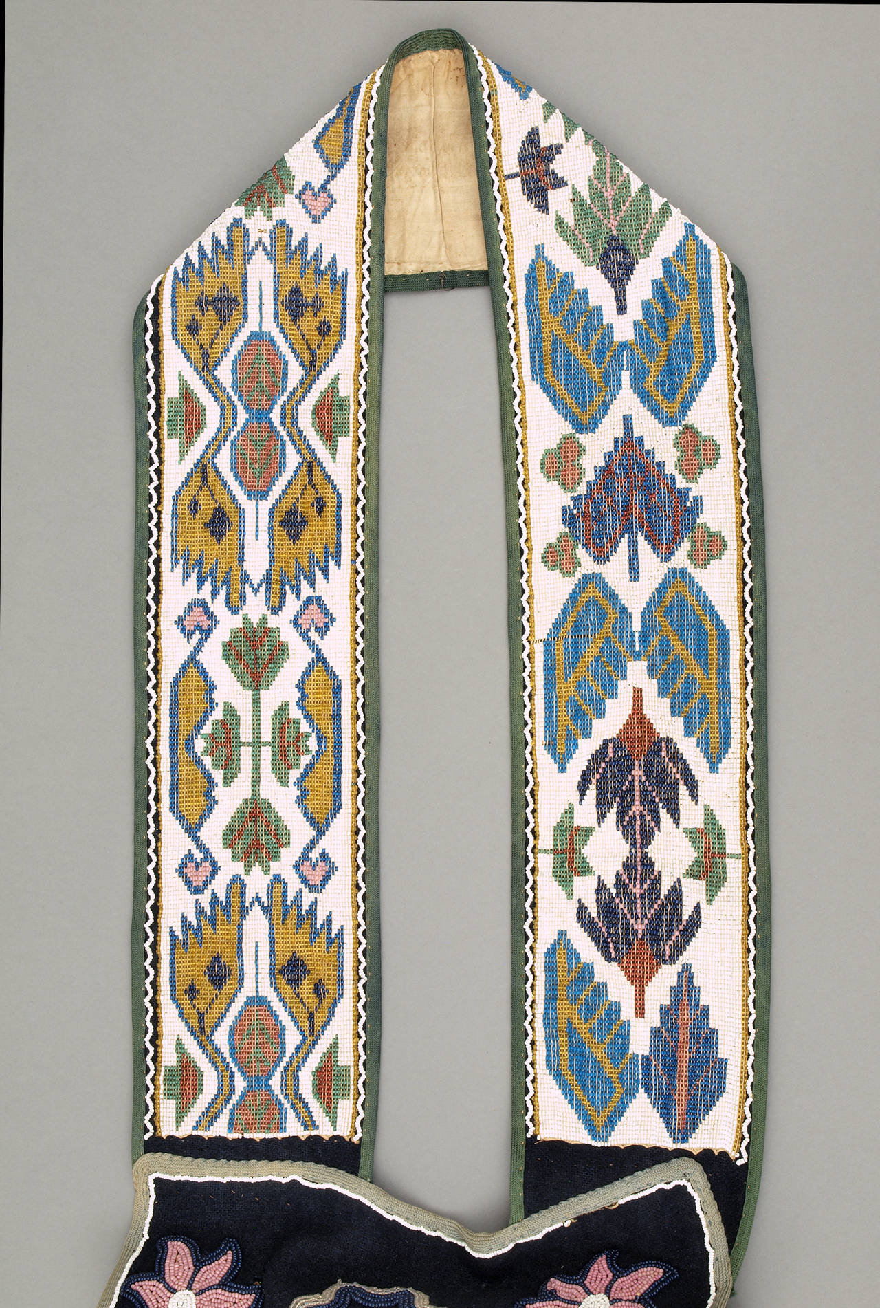 This Woodlands or Great Lakes bandolier bag is intricately beaded in geometric and foliate designs on trade cloth. 

Expedited and international shipping available; please contact us for a quote.
As with all our offerings, Authenticity is fully