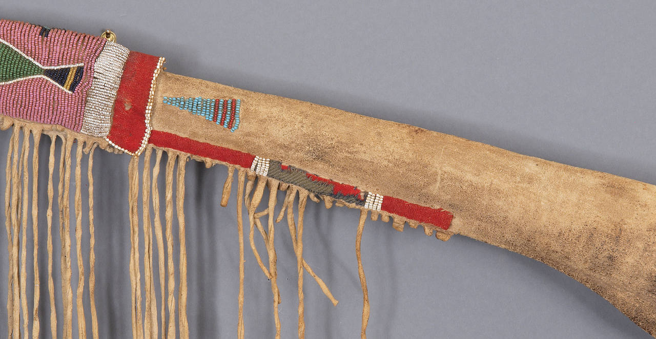 Antique Native American Crow (Plains Indian) rifle scabbard constructed of native tanned buffalo hide with a combination of Real and Trade beads in a Classic Crow/Northern Plains Indian design. Heavily fringed with Trade Cloth. This piece dates back