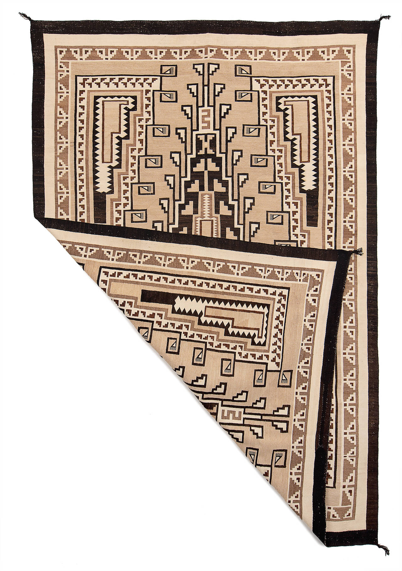 A spectacular Two Gray Hills textile created by master weaver, Cora Curley in an intricate design with elements similar to Crystal pattern rugs.  The Two Gray Hills Trading Post was established in 1897 on the Navajo Reservation near Tohatchi, New