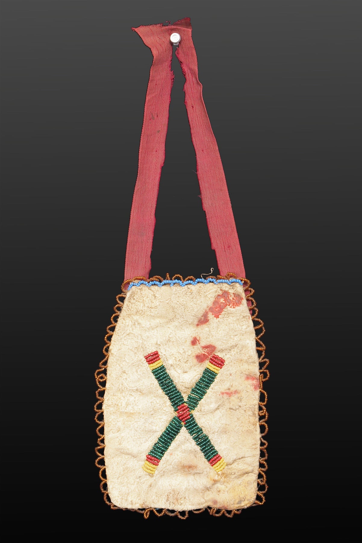 Sioux (Plains Indian) beadwork bag from the 19th century.  Constructed of native-tanned hide, the front is fully beaded with glass trade beads with two tepees (tipi) and stylized crosses along with the letters 