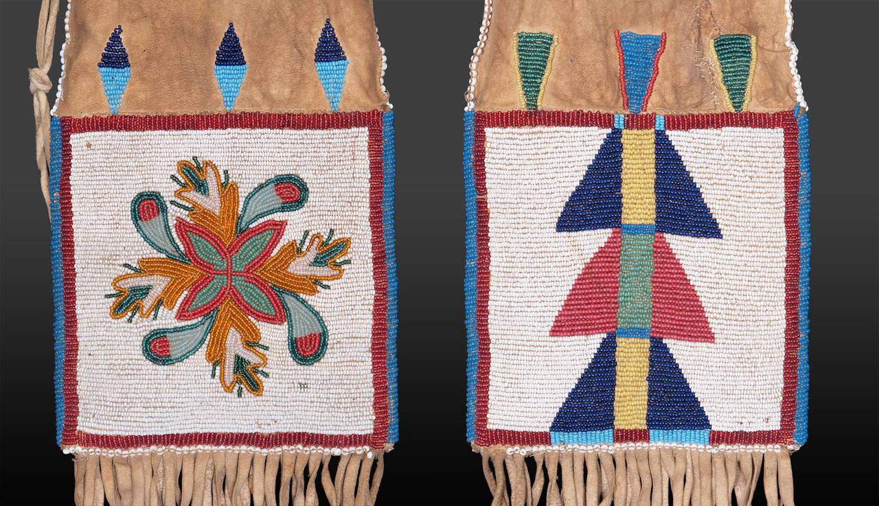 This remarkable tobacco bag was created during the 19th century. It is constructed of native-tanned hide with extensive fringe. A different design created from glass trade beads adorns either side. The first panel consists of a floriate motif while