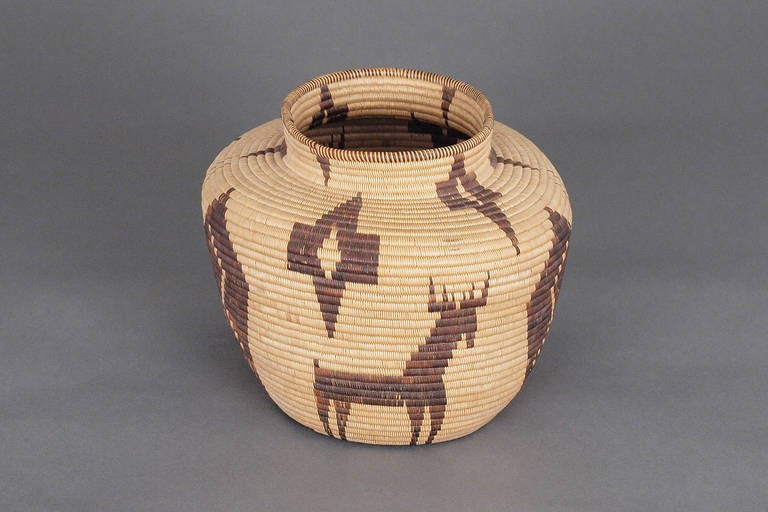 A Native American/North American Indian pictorial coiled basketry Jar.  Finely woven with geometric motifs and pictographs including stylized images of butterflies and deer by a Panamint (branch of the Shoshone peoples living in Southern California