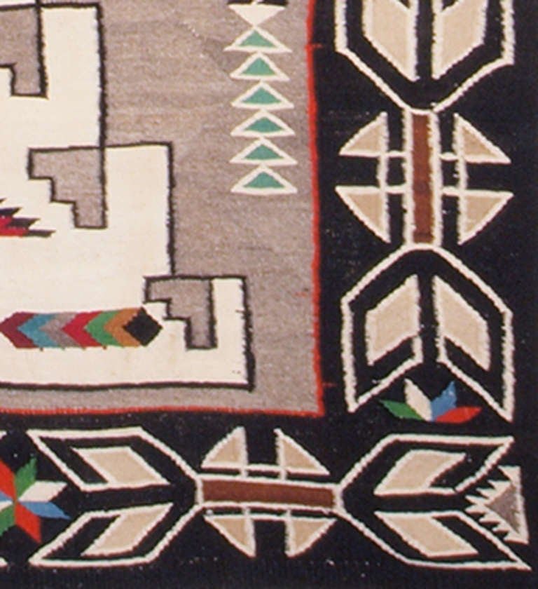 This large antique Trading Post rug was woven by a Navajo weaver in a design typical of the Teec Nos Pos Trading Post/Region.  Woven during the second quarter of the 20th century (1925-1949) it is well suited for use as a wall hanging or as a floor