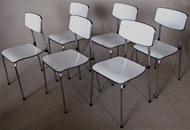 Set of Six German midcentury chairs, 1950

Set of six midcentury kitchen chairs from Germany, late 50th, slim lines, light grey finish of the hard vinyl veneer. Chairs are in 100% unrestored original condition ready to go another 50 years. Seat in