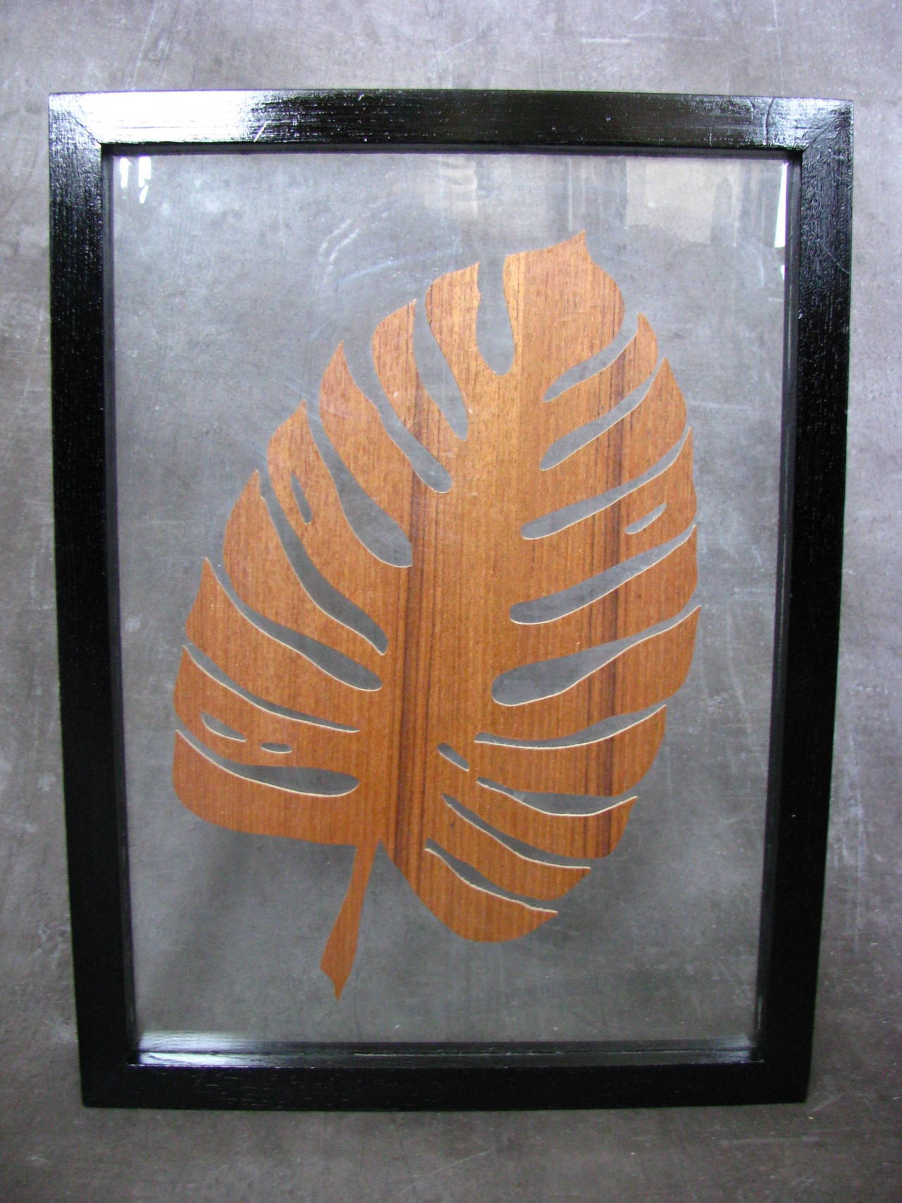 Rosewood Leaf in a Frame, Denmark, 1960s. Wooden artwork between two glass in a black polished wooden frame.

Measures: 
Length 44 cm (17.4 in).
Width 33 cm (13 in).

Note: Fine 1960s art work!

 
 