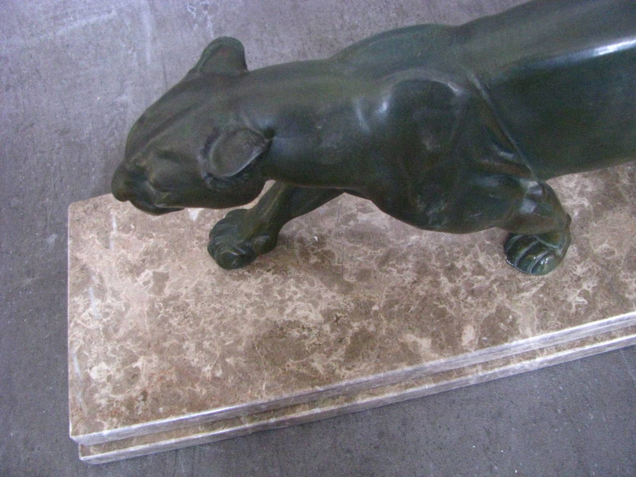 Art Deco panther sculpture, 1935.

Original Art Deco sculpture, France, circa 1935, bronze patinated regule on marble. 

 Height: 20 cm ( 7.9 in).
Length: 62 cm (24.4 in).
Width: 16 cm ( 6.3 in).

Note: Very natural Details!

Packing and