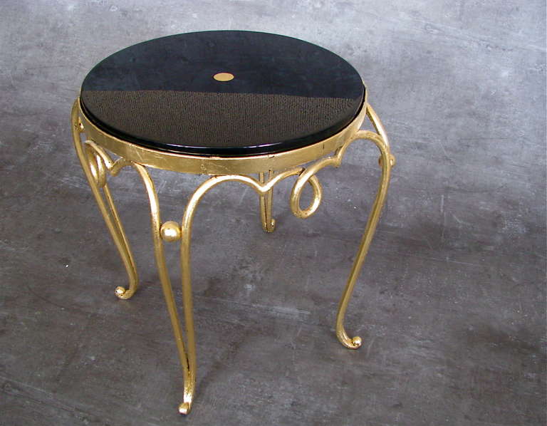 French Art Deco Side Table by Rene Prou 1925

Small wrought iron Table, gold leaf surface, table top in high gloss laquer hand polished with gold leaf detail.

Height   41 cm ( 16,2 in)
diameter  42 cm (  16,6 in )

Note:   Small Diamond in