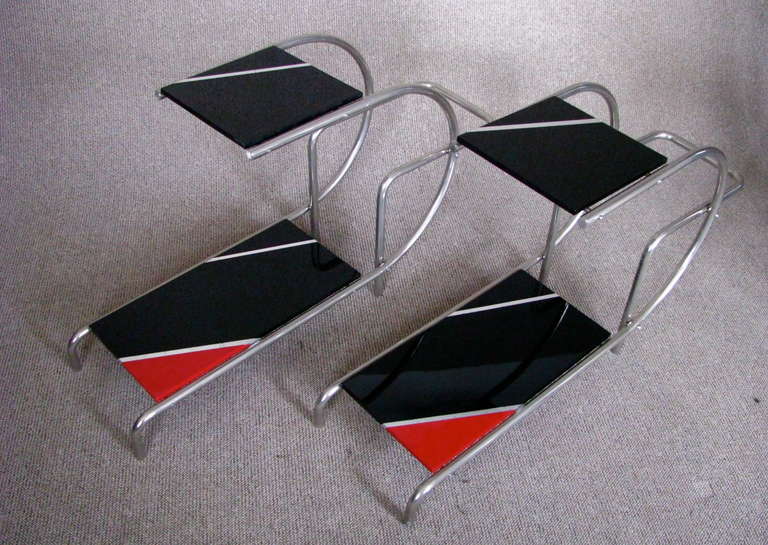A pair of nice pre-war chrome tube side tables. Chrome surface in good original condition. Wooden plates in black lacquer with red and silver leaf details in hand polished high gloss finish.

Measures: Height 56 cm (22.05 in)
Width 30 cm (11.8