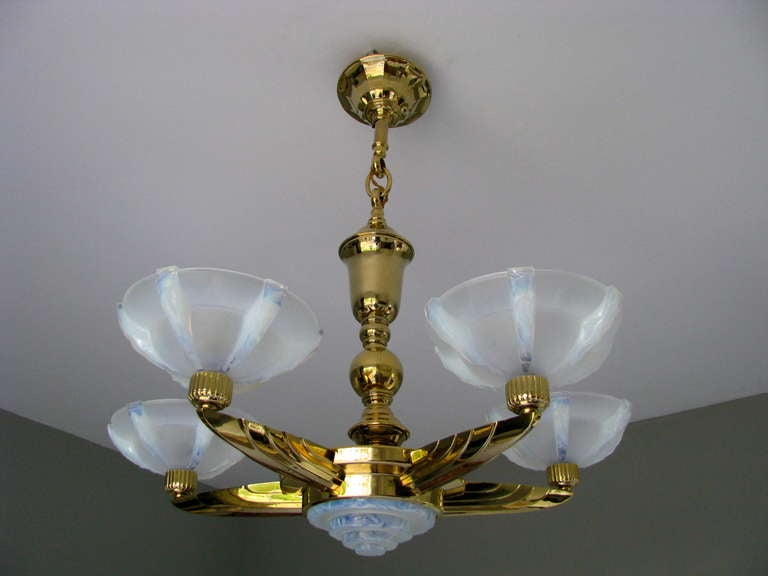 Original art deco chandelier by atelier petitot. 24K Gold plated bronze. Frosted/hammered shades in blue opalescent glas. 

Signed Petitot. 

6 ligths. newly rewired.

Width  73	cm 	( 28,8 in)
Length  	cm 	(  in)
Height  74	cm	( 28,9