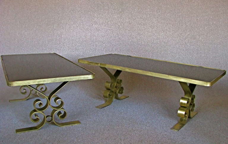 Pair of large Art Deco side/end Tables, France around 1940. Dim gold lacquer surface. Glass tops black.

height:  18 in  (45cm)
width: 23 in   (58cm)
length: 48  in   (122cm)

Note: Representative of the rare 1940th furniture!

We offer