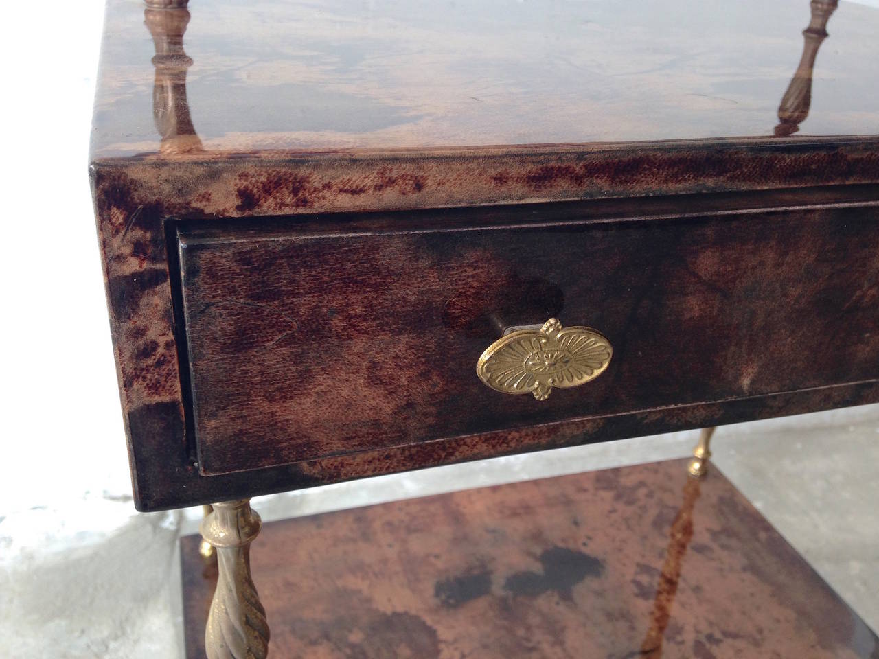 Aldo Tura brown goatskin parchment side table with one drawer. The table consisting to three levels and a drawer. Nice Brass details. 

Aldo Tura started in the 30's and fully developed in the 50's a successful business designing pieces that were