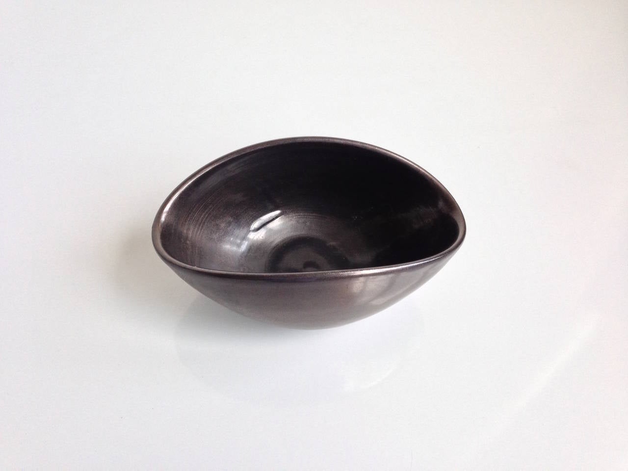 Suzanne Ramié (1907 - 1974) France

Ceramic oval bowl by renowned France artist Suzanne Ramié (Vallauris) having a light metallic black glaze. Incised on the bottom with the artist's 