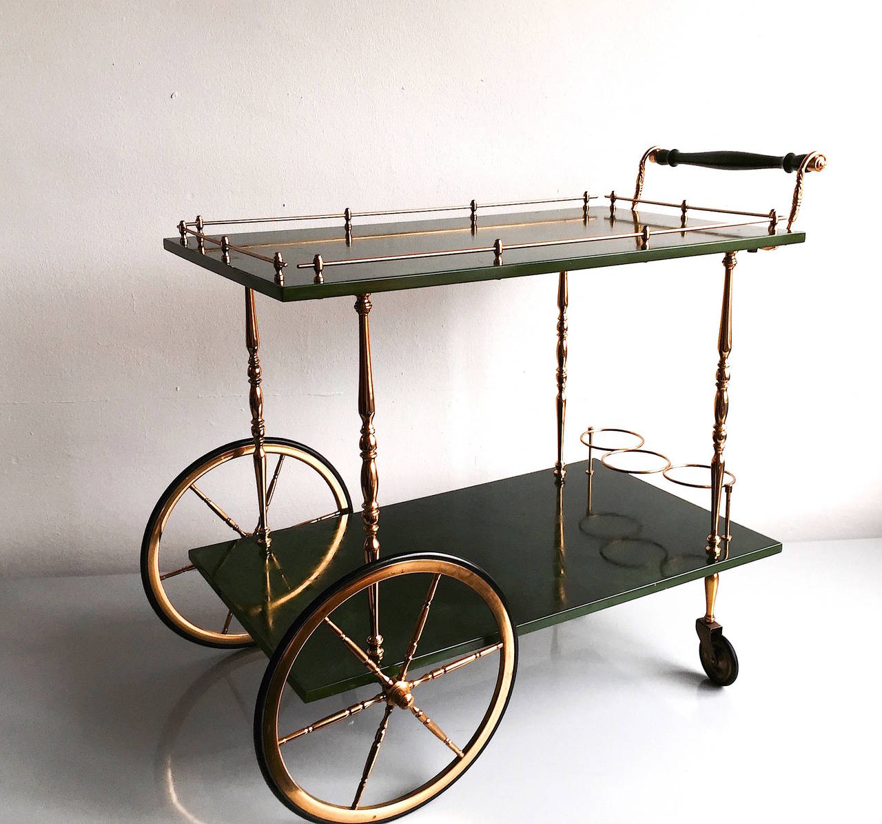Aldo Tura 

green goatskin parchment bar cart with two level. Nice Brass details. Nice conditions.

Aldo Tura started in the 30's and fully developed in the 50's a successful business designing pieces that were a mixture of sculptural