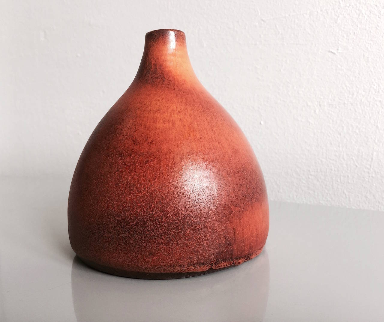 Suzanne Ramié ( 1907 - 1974) France

Ceramic vase by renowned France ceramic artist Suzanne Ramié having a red - orange fantastic glaze. The neck of the vase is light decentralized. Vallauris Clay. Incised on the bottom with the artist's