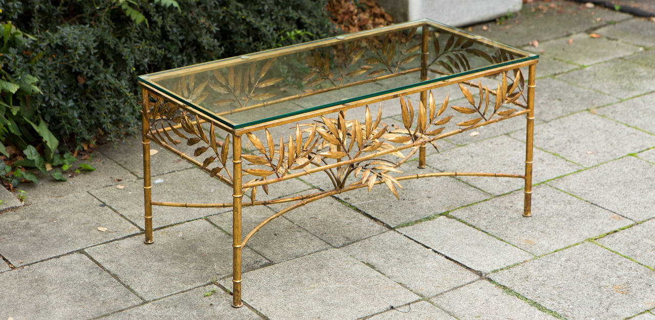 French coffee table with gold plated foliage base and glass top, 1950.