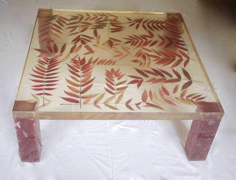 A rare and spectacular resin coffee table designed and edited by Pierre Giraudon. Resin including dried Fresno leaves. Excellent condition.
