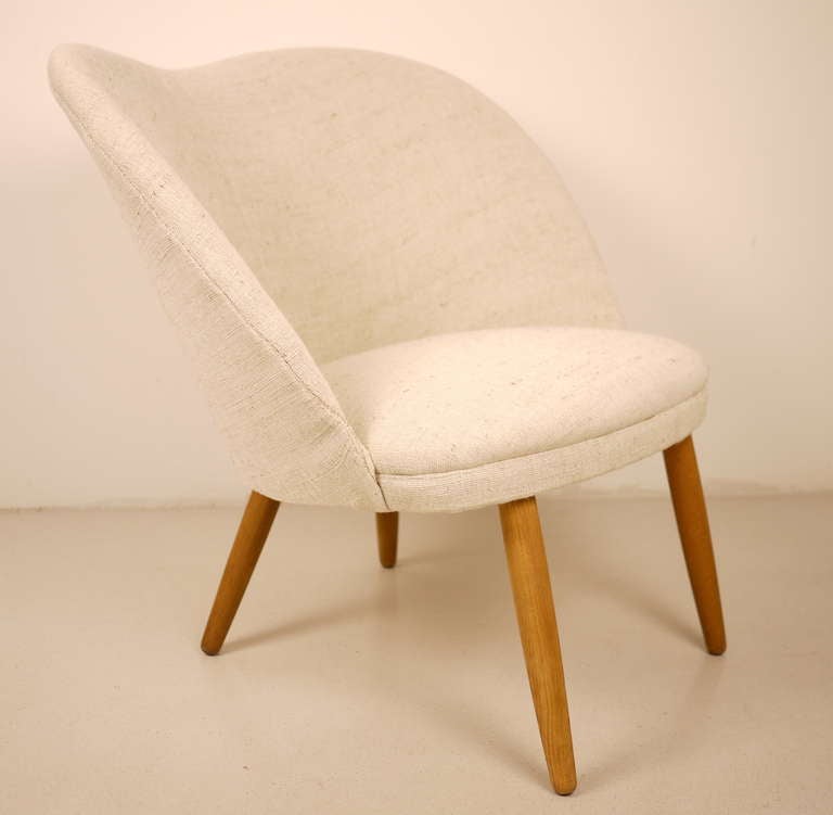A pair of 1950's Danish easy chairs designed by E. Johannesen.  Beech legs.  Fully upholstered in wild Indian linen.