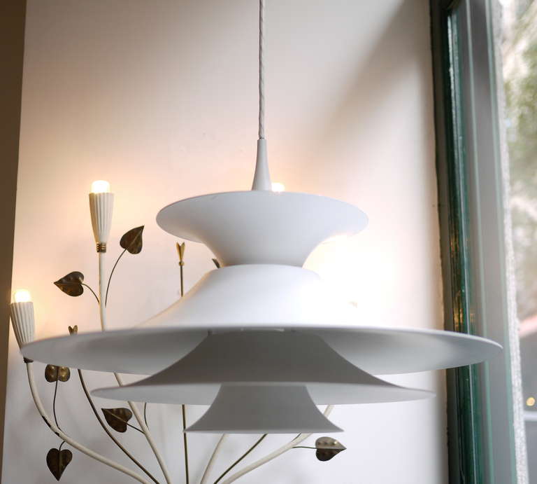 A radius pendant designed by Erik Baslev in white lacquered aluminum and edited by Fof and Morup.