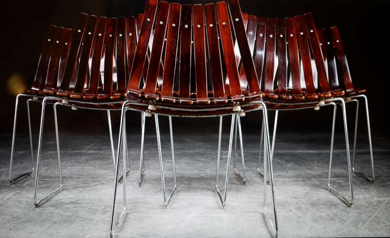 A set of six rosewood dining chairs designed in 1957 by Hans Brattrud and edited by Hove Mobler (Norway). Chromed-plated steel frame. Seat and backs with moulded rosewood slats. No longer in production.