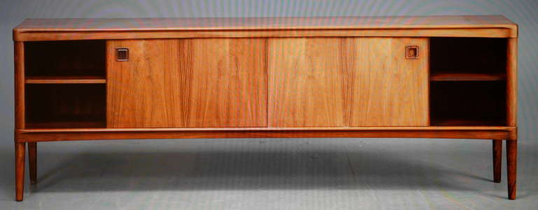A high quality Brazilian rosewood sideboard designed by H. W. Klein and edited by Bramin in the 60s .Brazilian rosewood frame , back included .Front with four drawers and two sliding doors.Cites Certificate included.