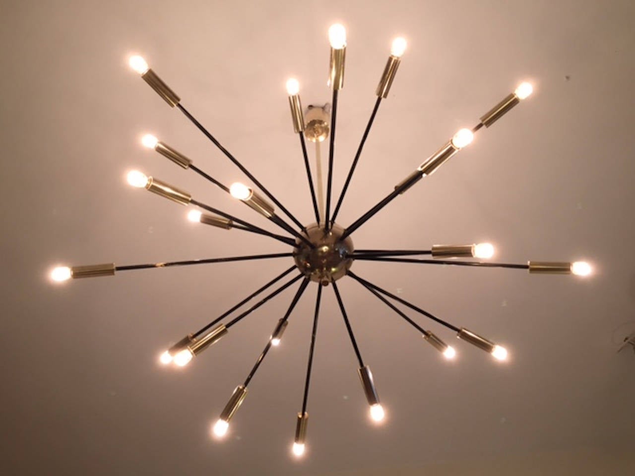 A huge Stilnovo brass Sputnik chandelier, edited by Stilnovo in the 1950s. The lamp is composed of 24 arms attached to a center ball and to a brass suspension stem. Excellent condition.