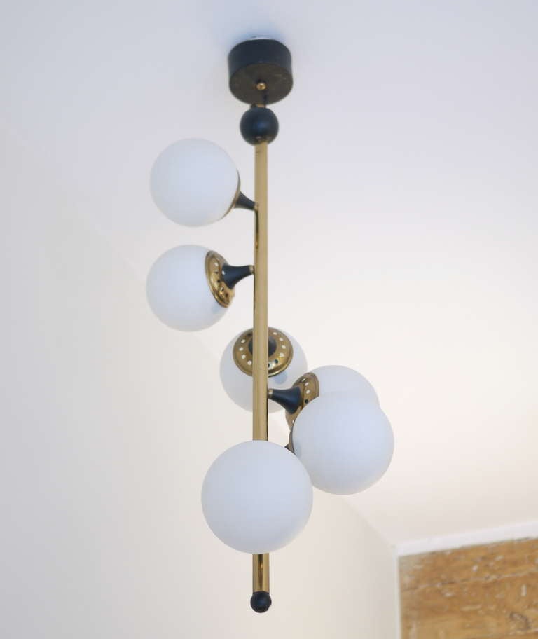 An original Italian 1950 chandelier. Edited by Stilnovo. Six frosted glass globes shades. Excellent condition. Rewired.It is not a reedition,