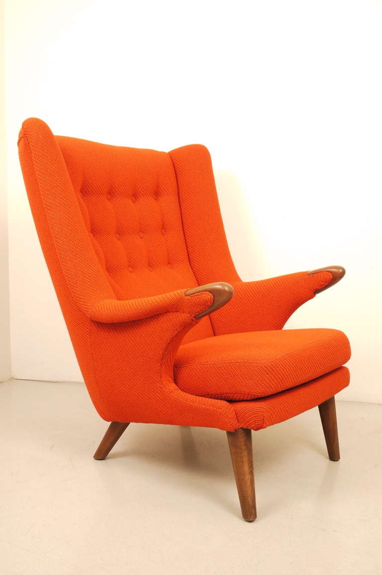 A Svend Skipper model 91 wingback chair . Edited by Skipper Furniture , Durup .Teak frame. Reupholstery in orange Kvadrat wool . Impeccable condition .