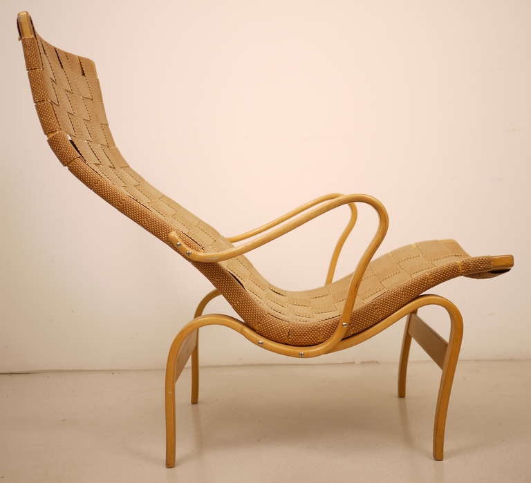 A lounge chair designed by Bruno Mathsson  and manufactured by Karl Mathsson.  Made of hemp webbing on a molded beech plywood frame.  Signed and stamped.