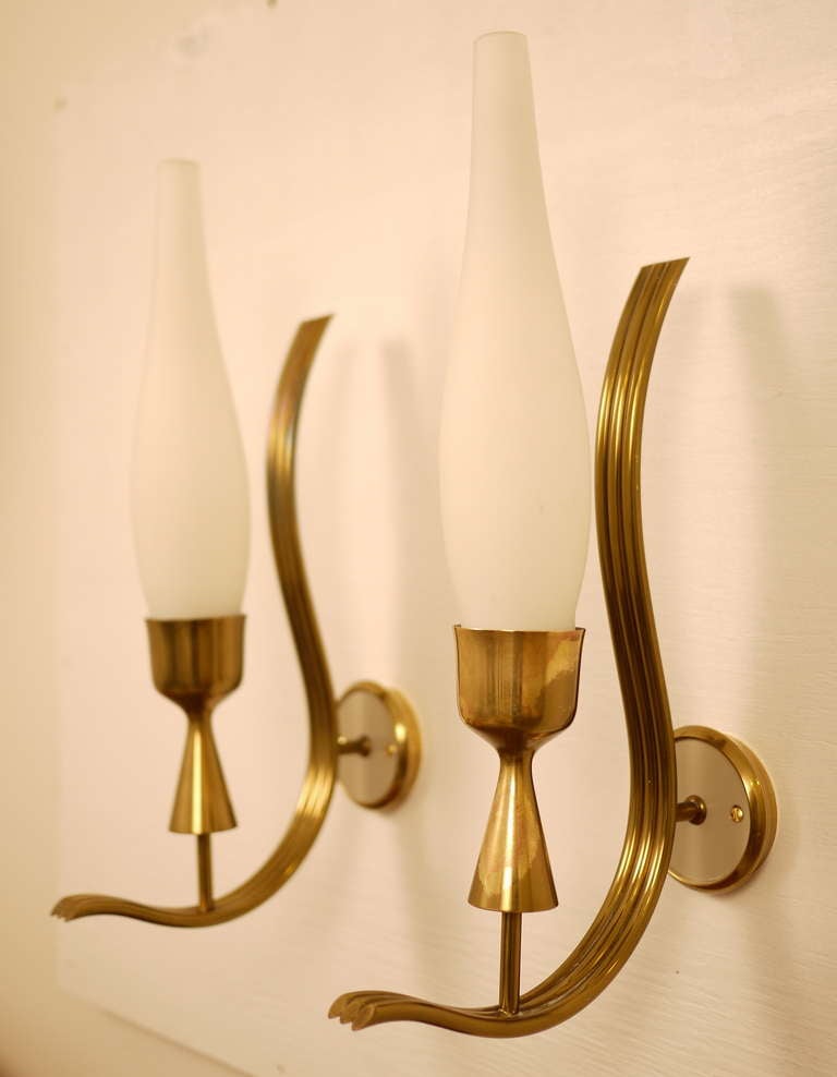 A pair of Angelo Lelli sconces manufactured by Stilnovo in the 1950s.  Bras frame and opaline reflectors .