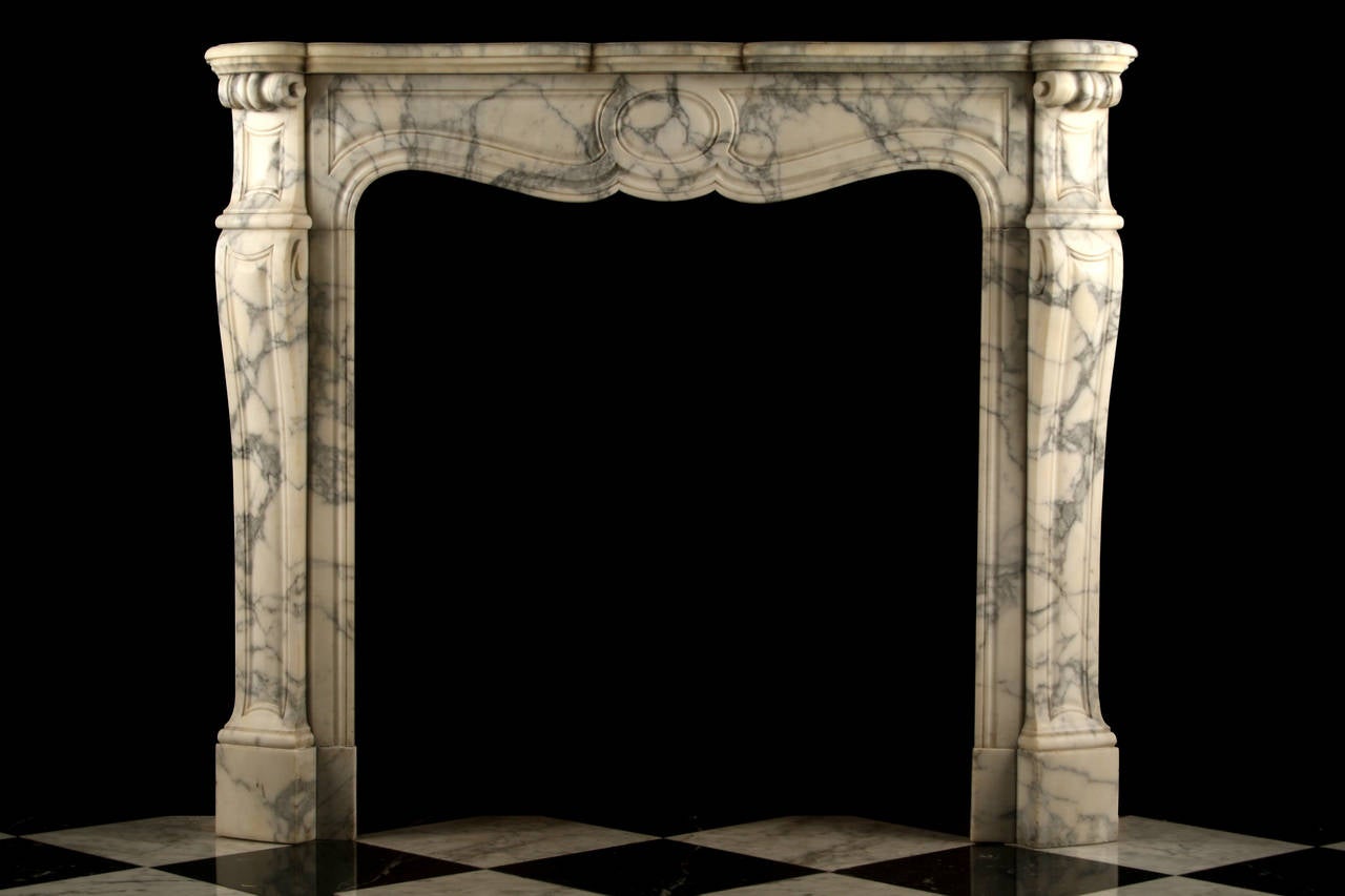 A Louis XV Pompadour Antique Fireplace Mantel very finely carved in elegantly veined Italian Arabescato marble, with a serpentine shelf over the finely carved panelled frieze and decoratively carved jambs, French Circa 1870.

Depth: 14 1/4